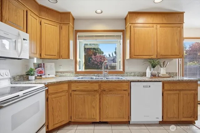 a kitchen with granite countertop a sink and cabinets