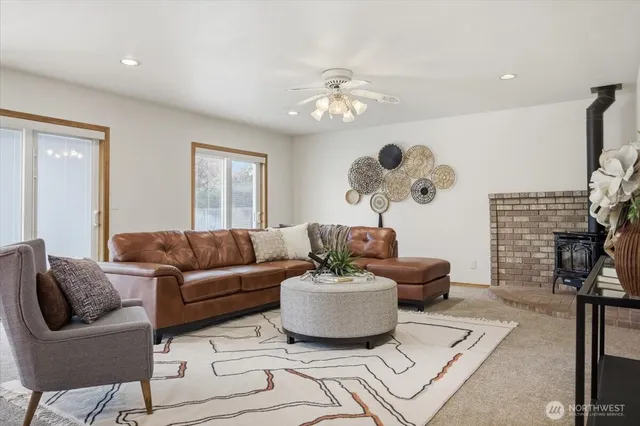a living room with furniture a chandelier and a fireplace