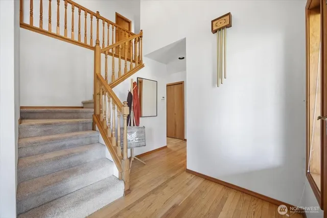 a view of entryway and hall with wooden floor