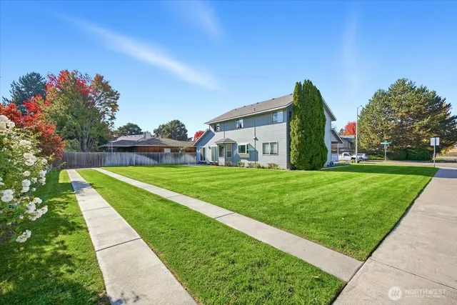 a view of green field with house in the background