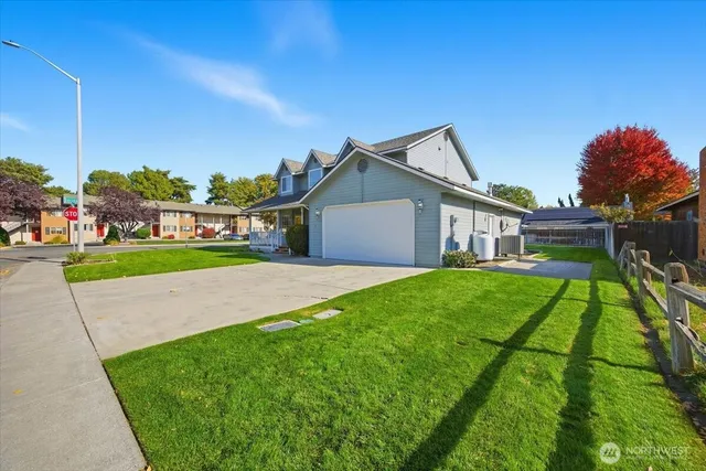 a view of backyard of house with green space