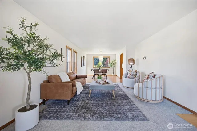a living room with furniture and a potted plant