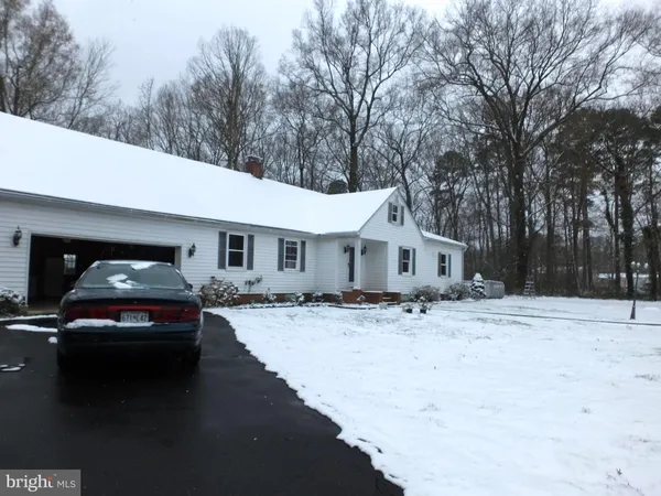 a house covered with snow in front of house