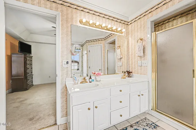 a bathroom with a sink a mirror a bathtub and shower