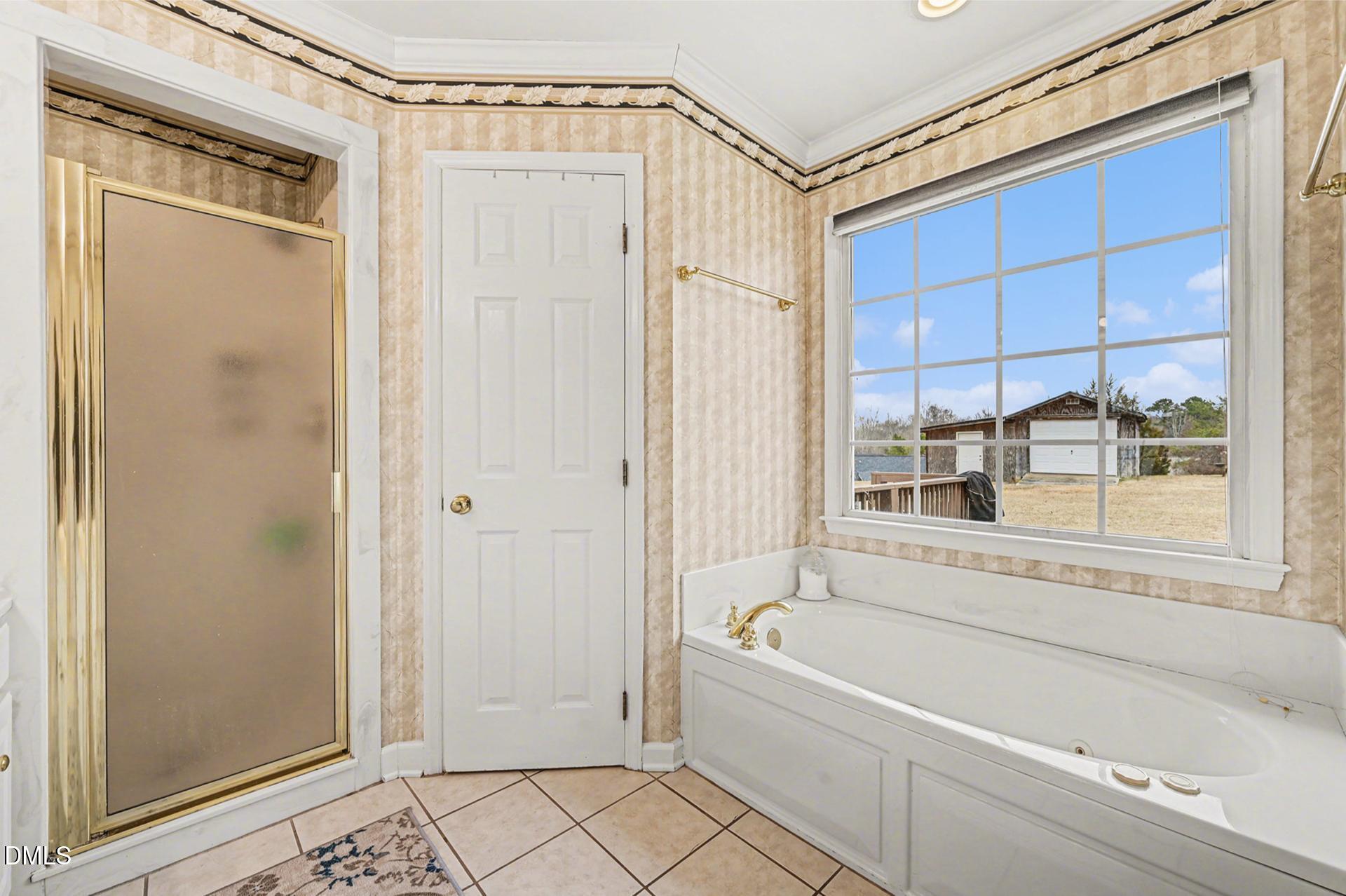 2070 Haw River Hopedale Road Burlington, NC 27217 - Photo 17 of 30 a bathroom with a bathtub and a shower