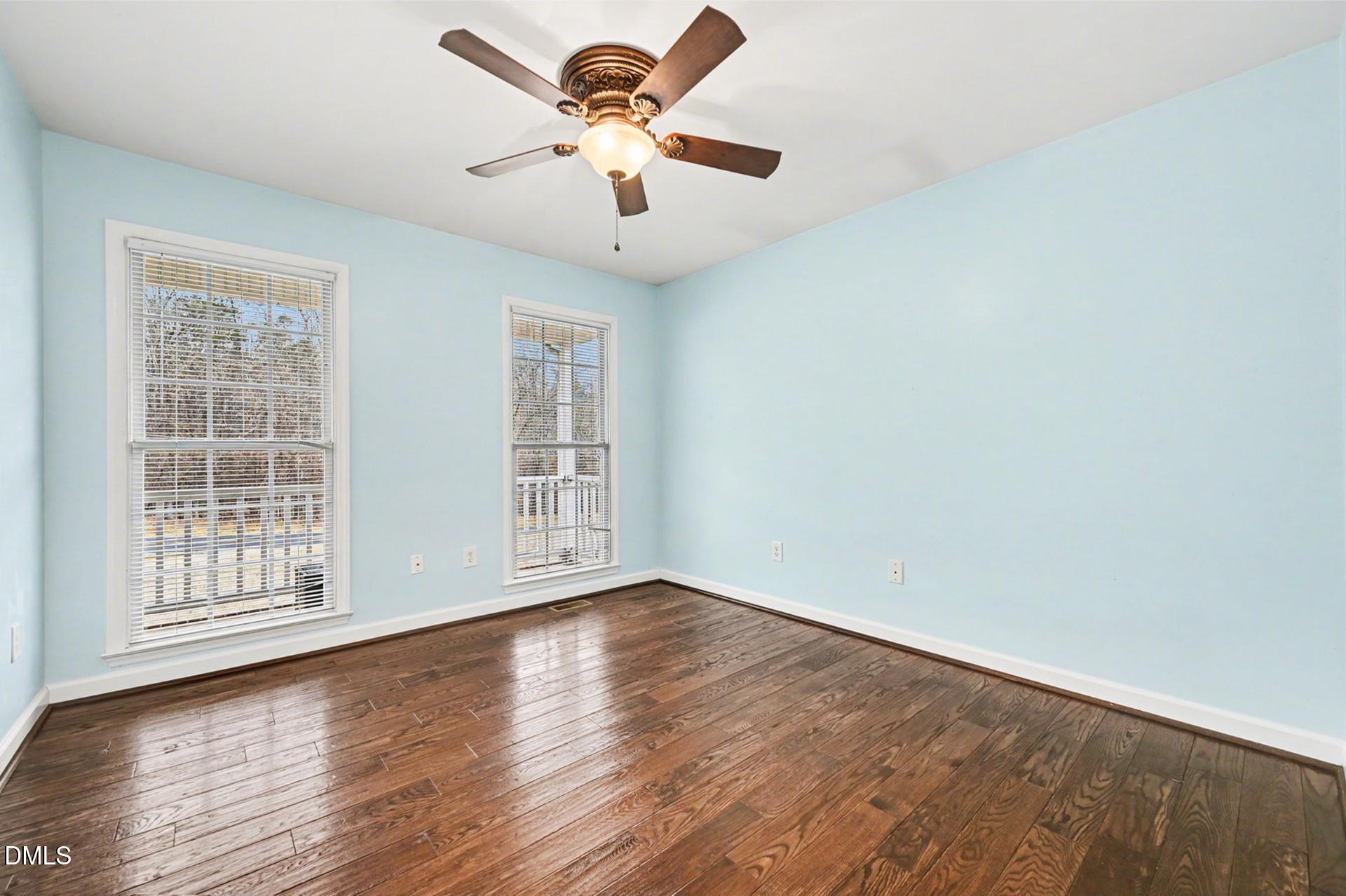 2070 Haw River Hopedale Road Burlington, NC 27217 - Photo 18 of 30 an empty room with wooden floor and windows