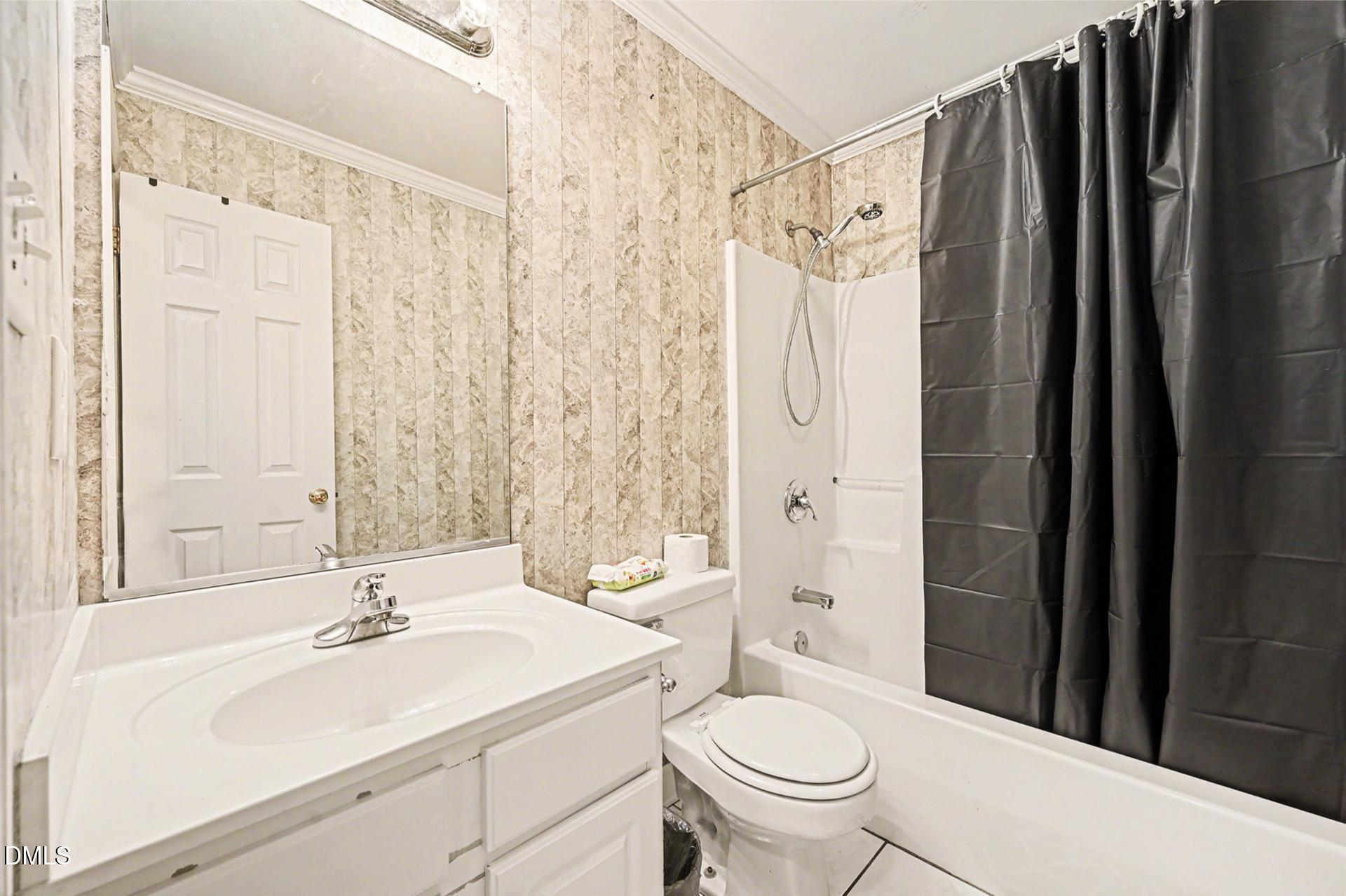 2070 Haw River Hopedale Road Burlington, NC 27217 - Photo 20 of 30 a bathroom with a sink a toilet and shower