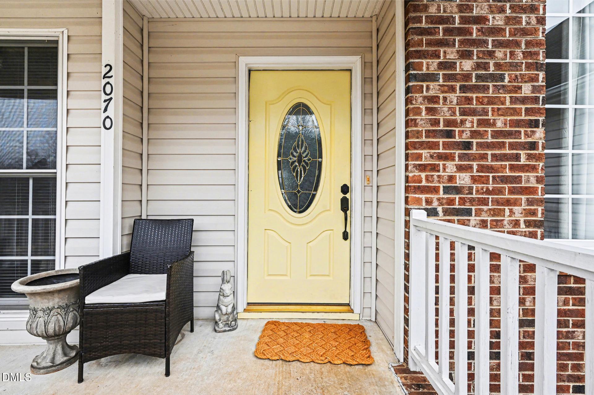 2070 Haw River Hopedale Road Burlington, NC 27217 - Photo 4 of 30 a front view of a house with outdoor seating