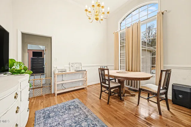 a living room with furniture and a table with wooden floor