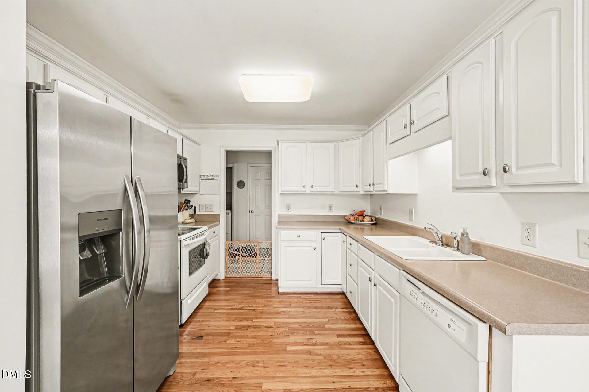 2070 Haw River Hopedale Road Burlington, NC 27217 - Photo 9 of 30 a kitchen with white cabinets and stainless steel appliances
