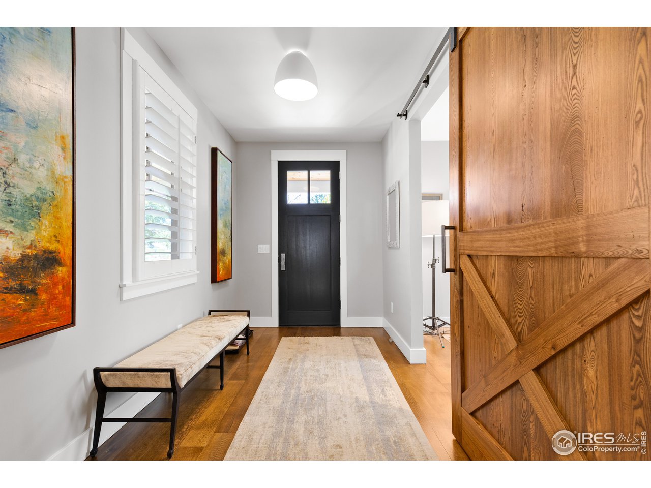 3191 9th Street Boulder, CO 80304 - Photo 16 of 40 a view of a hallway with wooden floor and staircase