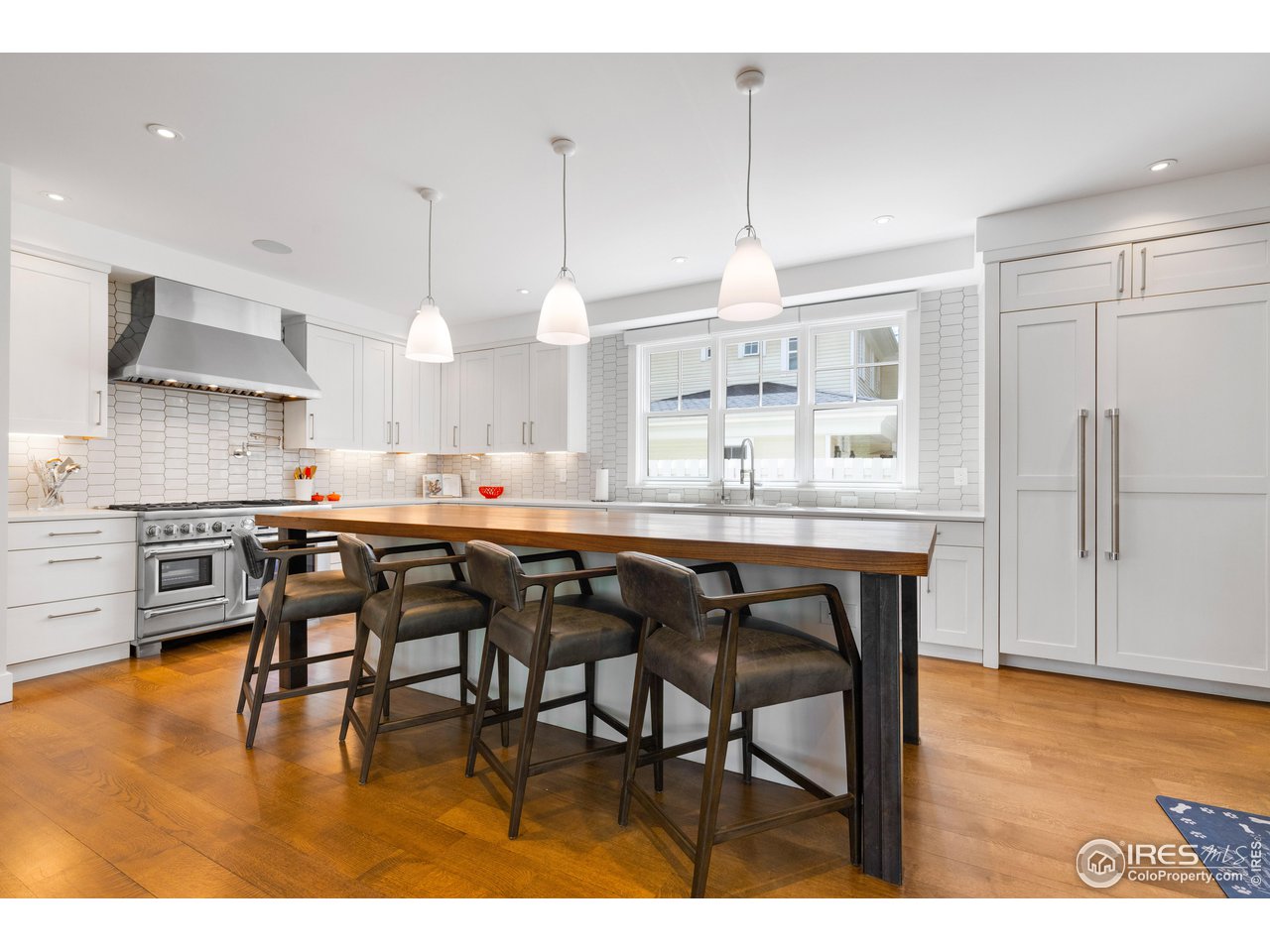 3191 9th Street Boulder, CO 80304 - Photo 2 of 40 a kitchen with stainless steel appliances granite countertop table chairs and a refrigerator