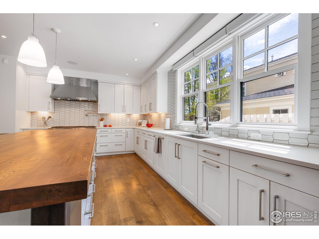 3191 9th Street Boulder, CO 80304 - Photo 3 of 40 a kitchen with a sink a window and cabinets