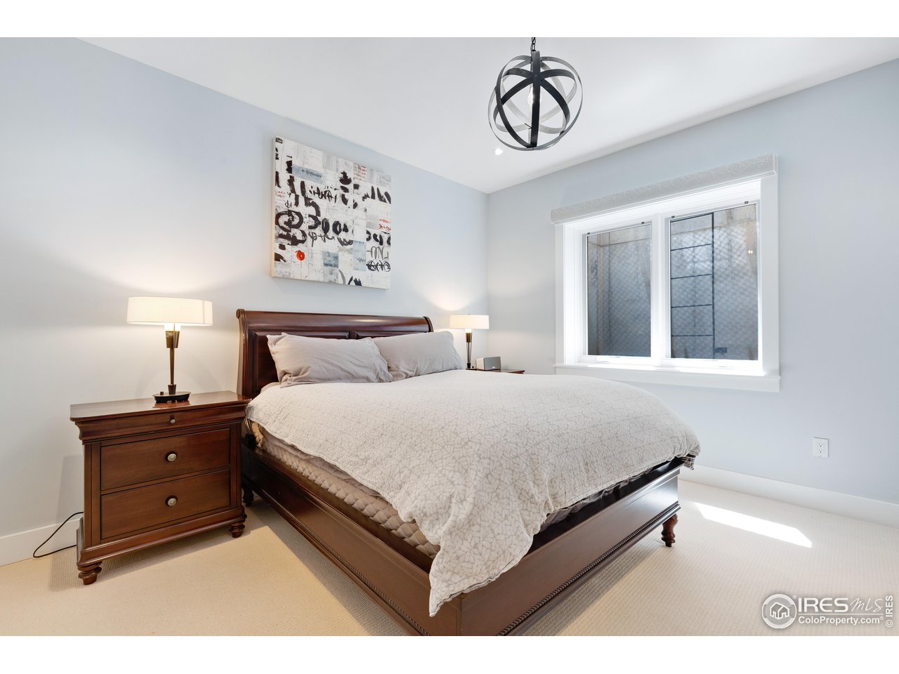 3191 9th Street Boulder, CO 80304 - Photo 35 of 40 a bedroom with a bed and painting on the wall