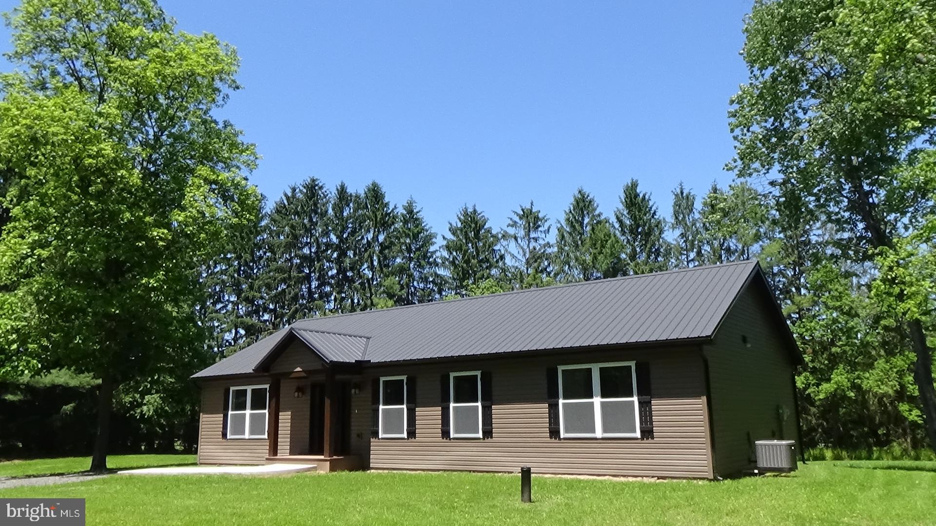 130 Soule Road New Bloomfield, PA 17068 - Photo 12 of 18 a front view of a house with a garden and trees