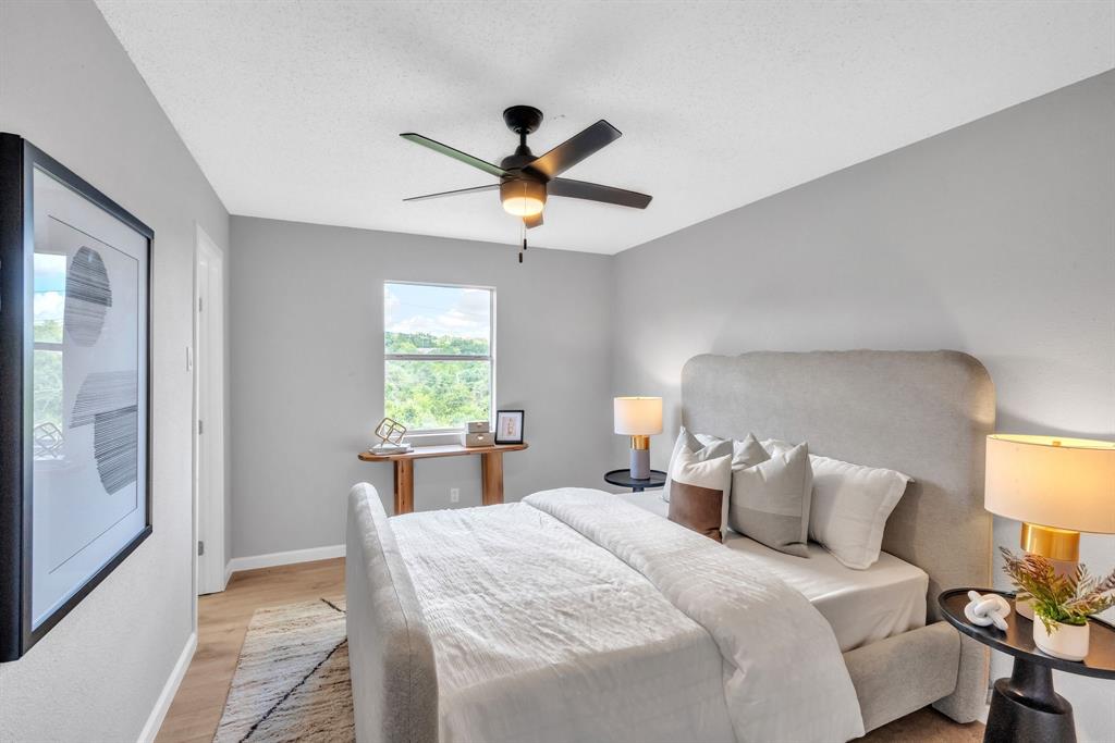 6914 Rifle Bend, Unit A Austin, TX 78736 - Photo 9 of 14 Warm wood flooring and neutral walls define this peaceful bedroom with a scenic window view.