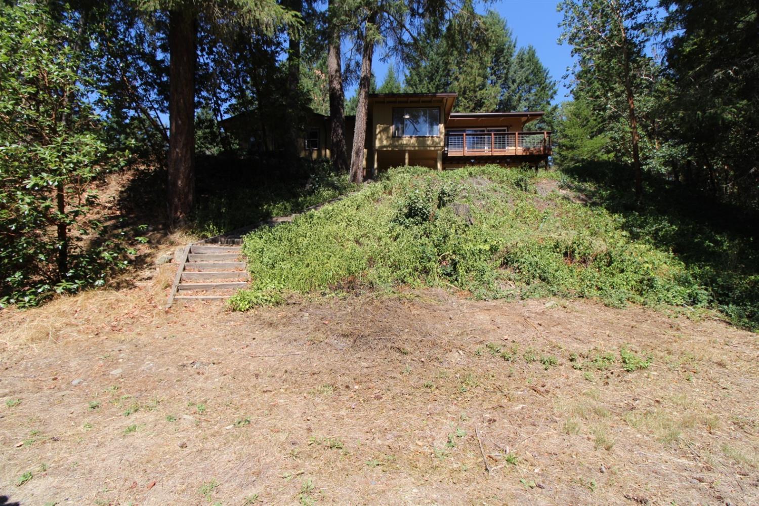 8775 North Applegate Road Grants Pass, OR 97527 - Photo 23 of 31 a backyard of a house with a yard and outdoor seating