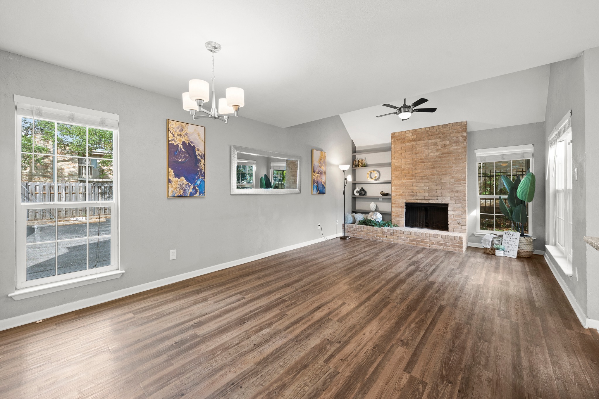 8330 Fathom Circle, Unit 501 Austin, TX 78750 - Photo 2 of 26 an empty room with wooden floor fireplace and windows