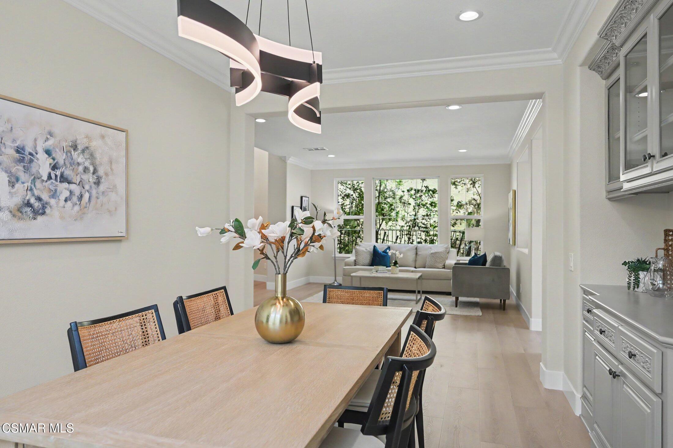20800 Sardinia Way Porter Ranch, CA 91326 - Photo 8 of 57 a view of a dining room with furniture a rug and wooden floor
