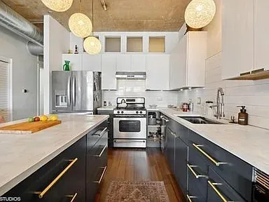 a kitchen with stainless steel appliances granite countertop a sink and cabinets