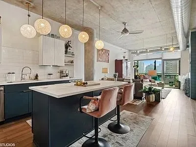 a kitchen with a sink appliances and cabinets