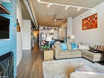 a living room with furniture and a flat screen tv