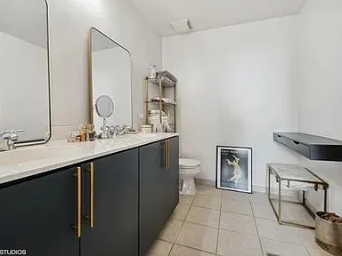 a bathroom with a sink a toilet and a mirror