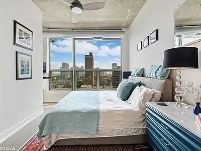 a bedroom with a large bed and a window