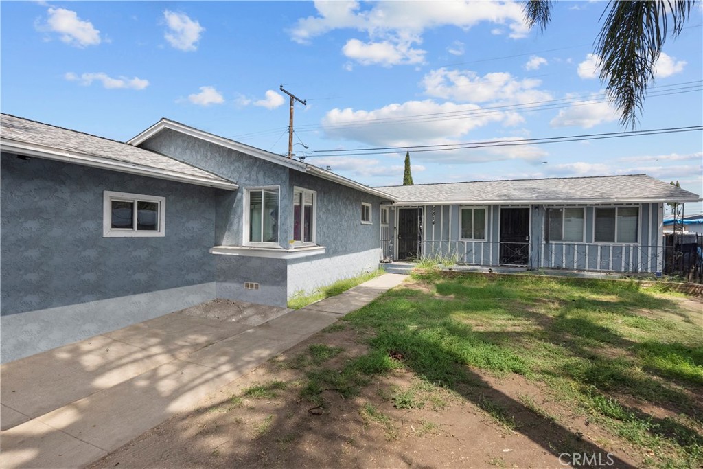 6814 Severn Drive Paramount, CA 90723 - Photo 1 of 1 a front view of a house with a garden