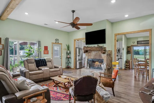 a living room with fireplace furniture and a flat screen tv