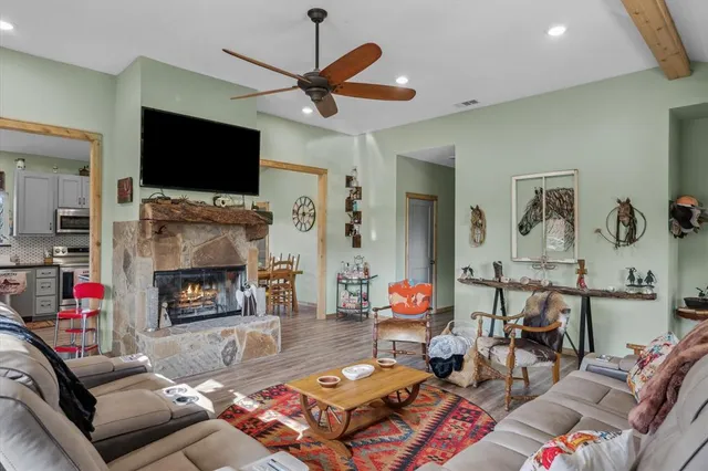 a living room with fireplace furniture and a flat screen tv