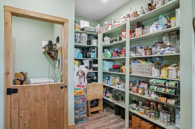 a room with lots of books and a wooden floor