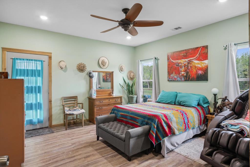 9292 County Road 346 Terrell, TX 75161 - Photo 25 of 40 a bedroom with a bed and a chandelier