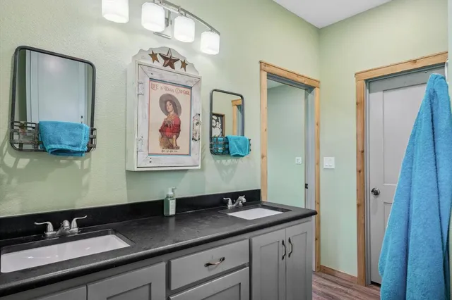 a bath room with a sink and a mirror