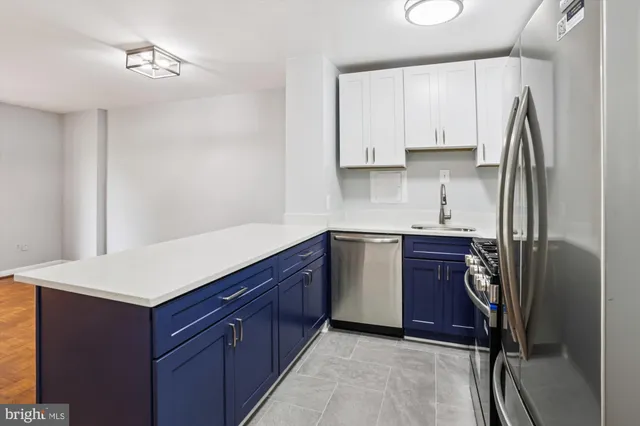 a kitchen with stainless steel appliances granite countertop a stove and a microwave