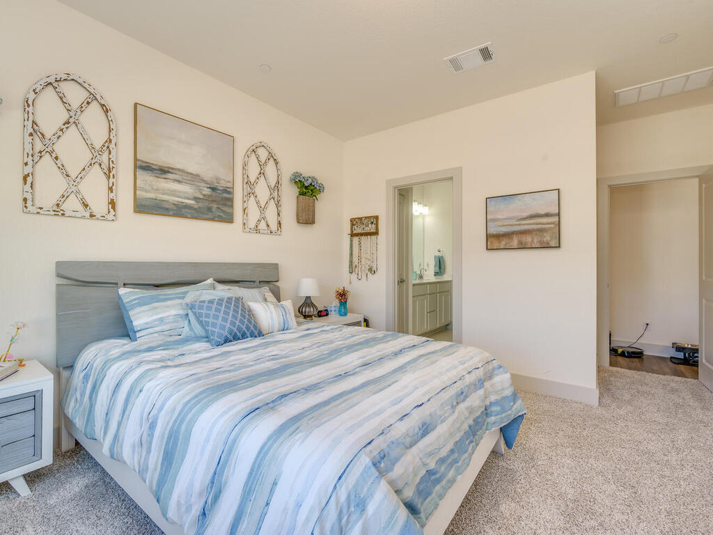 2257 Local Rebel Loop Leander, TX 78641 - Photo 16 of 26 a bedroom with a bed and wall painting