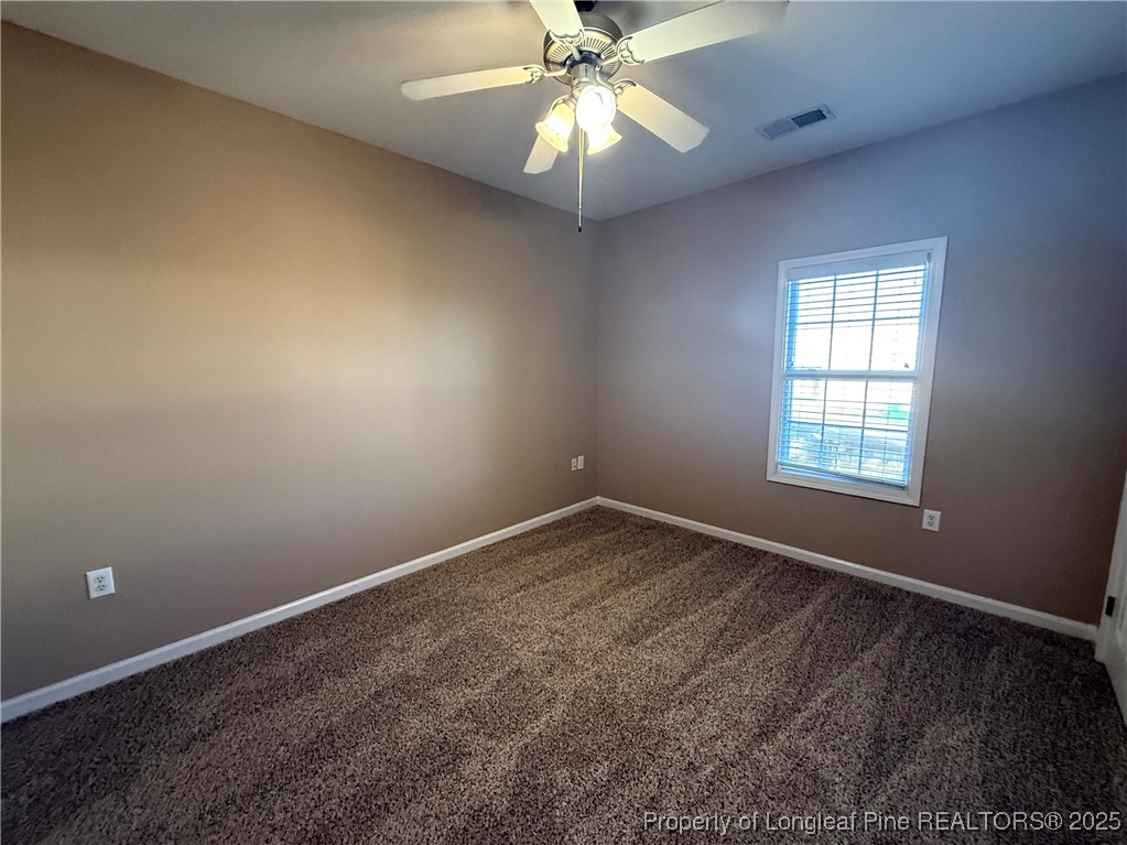 635 Marsh Tree Street, Unit 208 Fayetteville, NC 28314 - Photo 12 of 20 an empty room with a window and a fan