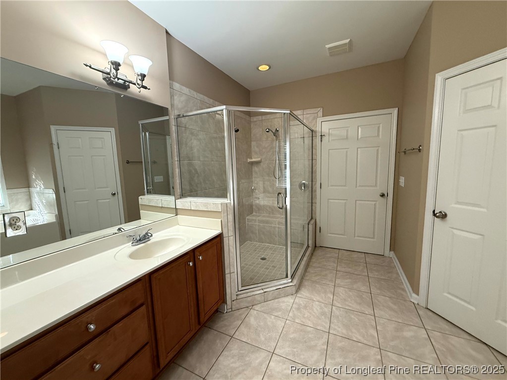 635 Marsh Tree Street, Unit 208 Fayetteville, NC 28314 - Photo 18 of 20 a bathroom with a shower sink and mirror