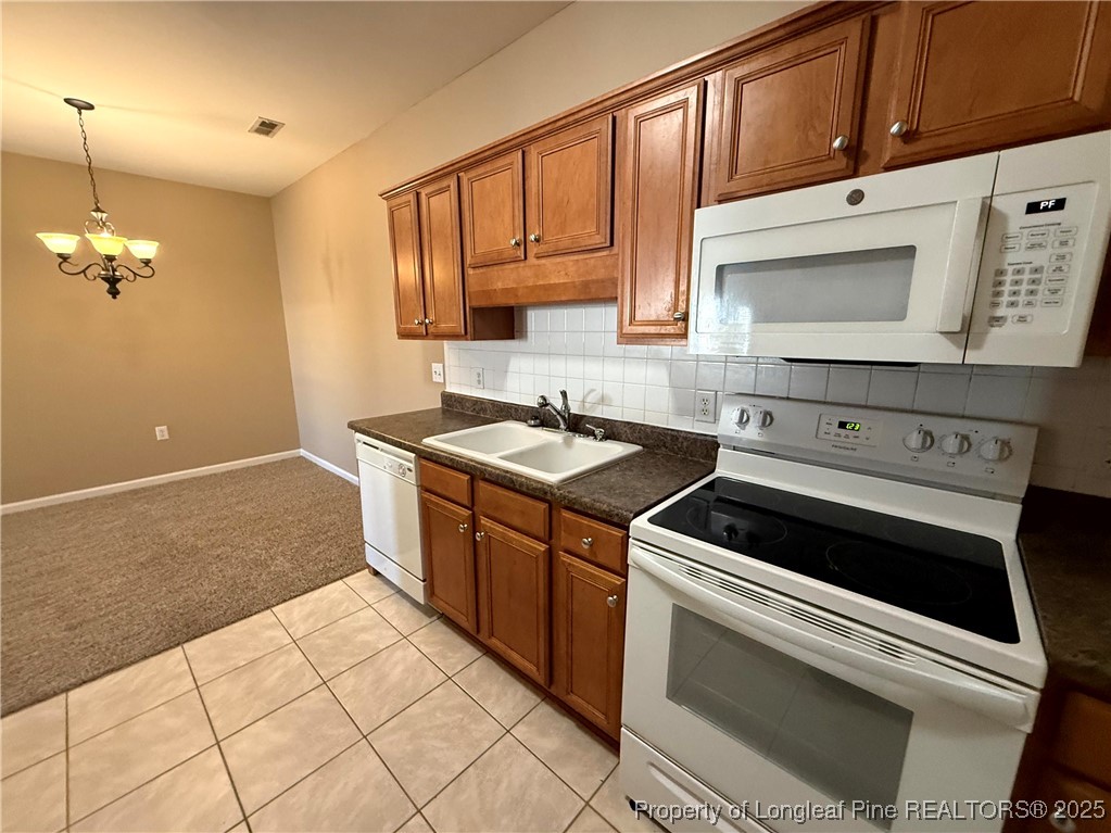 635 Marsh Tree Street, Unit 208 Fayetteville, NC 28314 - Photo 5 of 20 a kitchen that has a sink and a stove