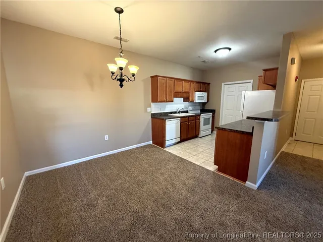 a view of kitchen with sink refrigerator and microwave