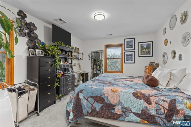 a bedroom with a bed furniture and a flat screen tv