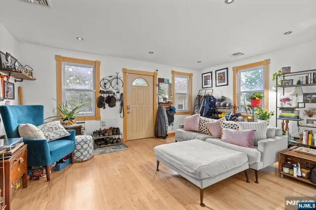 a living room with furniture and wooden floor