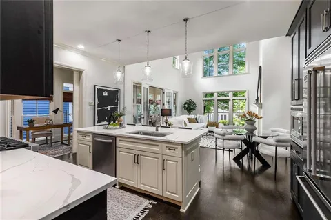 a kitchen with stainless steel appliances a sink stove and cabinets