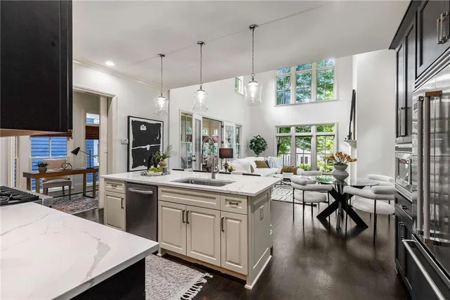 a kitchen with stainless steel appliances a sink stove and cabinets