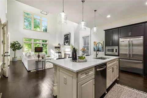a living room with furniture wooden floor and a large window