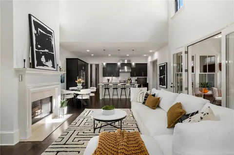 a living room with furniture fireplace and a large window