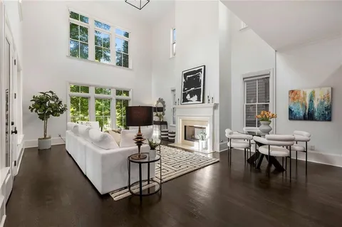 a living room with fireplace furniture and a wooden floor