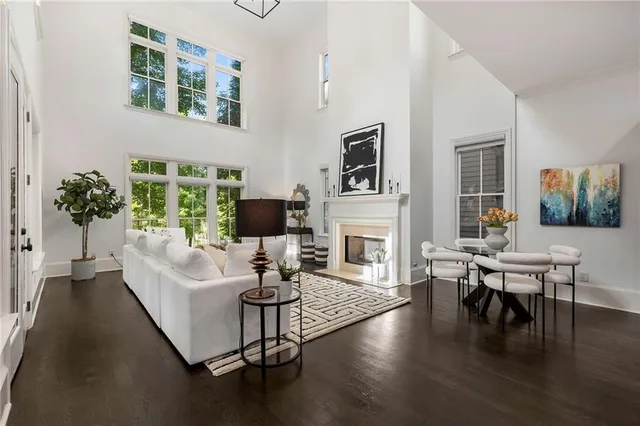 a living room with fireplace furniture and a wooden floor