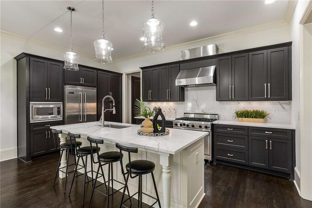 147 Hubbard Road Woodstock, GA 30188 - Photo 3 of 56 a kitchen with a stove a refrigerator and a microwave