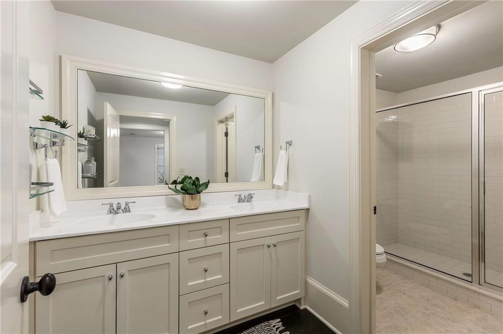 147 Hubbard Road Woodstock, GA 30188 - Photo 33 of 56 a bathroom with a double vanity sink mirror and shower